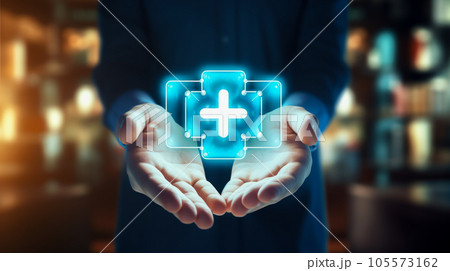 View of a Businessman holding a medical icon displayed on a futuristic interface 105573162