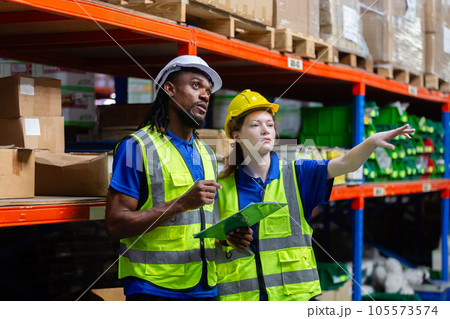 Group worker warehouse working brainstorm checklist product to shelf in warehouse store. 105573574