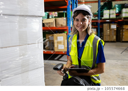 Female blonde hair factory company employee scanning box checking number of products. Female blonde hair factory company employee scanning box checking number of products. 105574668