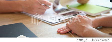 Doctor checking patient ultrasound scan results at his desk. Doctor checking patient ultrasound scan results at his desk. 105575802