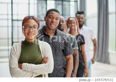 a group of black people stand in a row led by a girl 105576531