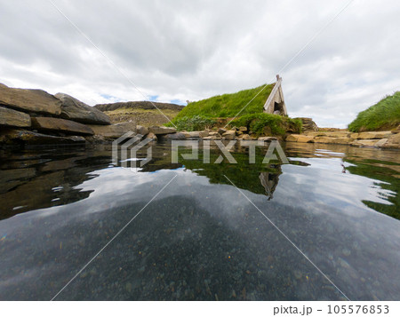 Hot spring pool and a turf house in Hrunalaug, Iceland 105576853
