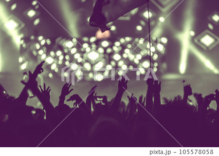 Crowd of audience with hands raised at a music festival 105578058