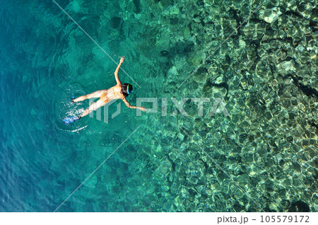 Sexy woman snorkeling in tropical sea Sexy woman snorkeling in tropical sea 105579172