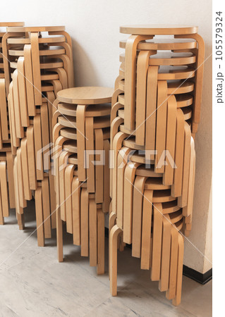 Stacked wooden stools made from bent plywood Stacked wooden stools made from bent plywood 105579324