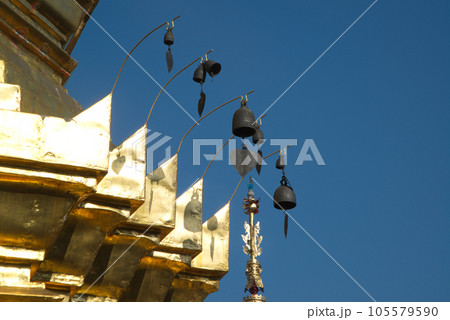 Golden tiered umbrella and the corner of golden Buddhist pagoda in Wat Pa Pathomchai , Located at Nakhon Pathom Province in Thailand. 105579590