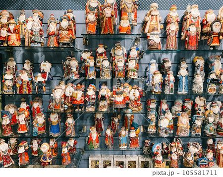 Figurines of St. Nicholas with bags of gifts are on the shelves of the store Figurines of St. Nicholas with bags of gifts are on the shelves of the store 105581711