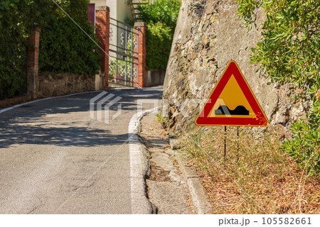 Triangular Road Sign of Bumpy Road - Liguria Italy Europe Triangular Road Sign of Bumpy Road - Liguria Italy Europe 105582661