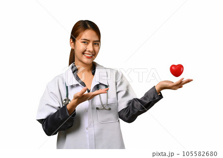 Image of female doctor holding stethoscope and red heart isolated white background. Cardiology, medicine and healthcare concept. Image of female doctor holding stethoscope and red heart isolated white background. Cardiology, medicine and healthcare concept. 105582680