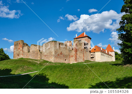 View of Latvian tourist landmark attraction -  ruins of old medieval Bauska castle and the remains of a later palace. Bauska, Latvia. 105584326