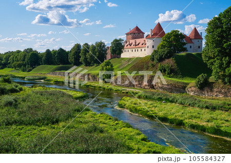 View of Latvian tourist landmark attraction - ruins of old medieval Bauska castle and the remains of a later palace. Bauska city, Latvia. View of Latvian tourist landmark attraction - ruins of old medieval Bauska castle and the remains of a later palace. Bauska city, Latvia. 105584327
