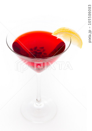 Pomegranate cosmo cocktail with lemon as a garnish. Pomegranate cosmo cocktail with lemon as a garnish. 105586083