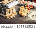 Different dry pasta with flour on grey table 105588521