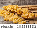 raw pasta pipe rigate on rustic wood 105588532
