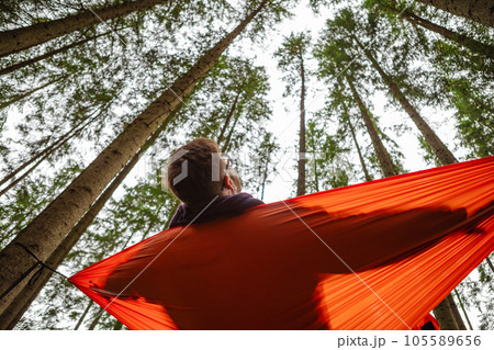happy man in hammock in the middle of the forest 105589656