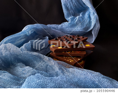 Pieces of chocolate. With berries, strawberries, oranges. 105590446