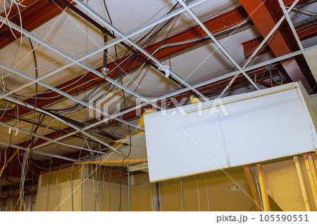 Ceiling works within construction complex encompass removal of old ceiling during interior building reconstruction. 105590551
