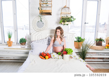healthy nutrition and pregnancy. pregnant woman's belly and vegetable salad healthy nutrition and pregnancy. pregnant woman's belly and vegetable salad 105592659