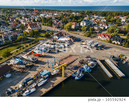 small port with ships and loading crane, Jastarnia, Hel peninsula, Poland aerial 105592924