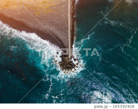 ocean blue water waves and stone breakwater with black beach, Tenerife, Canary ocean blue water waves and stone breakwater with black beach, Tenerife, Canary 105592926