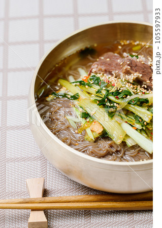 Yeolmunaengmyeon, korean style Buckwheat Noodles with YoungSummer Radish Kimchi, This dish features cold noodles in kimchi soup that is made by mixing salted young radish with chopped onion, chives 105597933