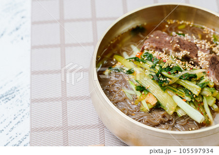 Yeolmunaengmyeon, korean style Buckwheat Noodles with YoungSummer Radish Kimchi, This dish features cold noodles in kimchi soup that is made by mixing salted young radish with chopped onion, chives 105597934
