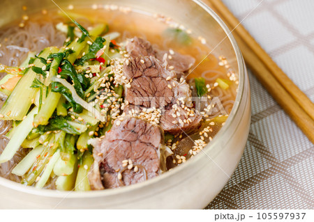 Yeolmunaengmyeon, korean style Buckwheat Noodles with YoungSummer Radish Kimchi, This dish features cold noodles in kimchi soup that is made by mixing salted young radish with chopped onion, chives 105597937