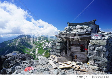 剱岳山頂の祠と奥に立山 剱岳山頂の祠と奥に立山 105598448