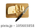 Cheese on a wooden board isolated on white background. Hard cheese cut into pieces. 105603858