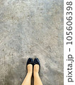 woman standing on concrete street  105606398