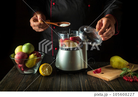 The chef adds sugar to the blender to make a sweet fruit drink. Healthy vegetarian breakfast idea The chef adds sugar to the blender to make a sweet fruit drink. Healthy vegetarian breakfast idea 105608227