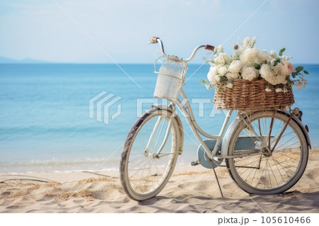 Vintage bicycle at beach in morning with wicker basket and flowers 105610466