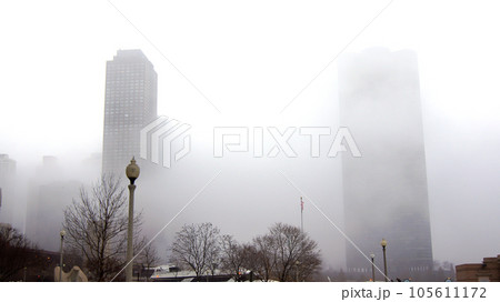 CHICAGO, ILLINOIS, UNITED STATES - DEC 12, 2015: Downtown Chicago skyscrapers in the fog on an overcast winter day CHICAGO, ILLINOIS, UNITED STATES - DEC 12, 2015: Downtown Chicago skyscrapers in the fog on an overcast winter day 105611172