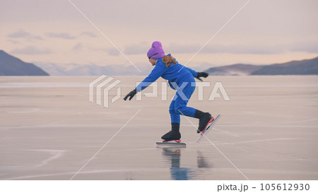 The child train on ice professional speed skating. The girl skates in the winter in sportswear, sport glasses, suit. Outdoor slow motion. The child train on ice professional speed skating. The girl skates in the winter in sportswear, sport glasses, suit. Outdoor slow motion. 105612930