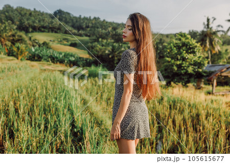 Gorgeous young woman on rise terraces in Bali with morning sunlight. Glamour lady at rice field 105615677