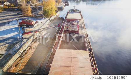 Loading wheat grain into barge, port and food industry grain silos in the port of Ukraine 105615994