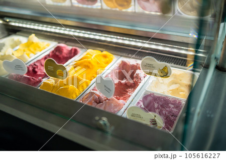 Ice cream flavors display for sale as summer takeaways displayed in metal trays  105616227