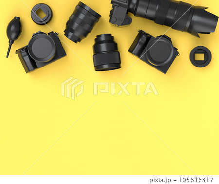 Top view of monochrome designer workspace and photography gear on yellow 105616317