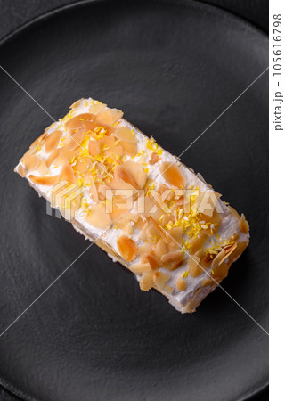 Delicious, fresh, sweet meringue roll with cream, almond chips, nuts and berries Delicious, fresh, sweet meringue roll with cream, almond chips, nuts and berries 105616798