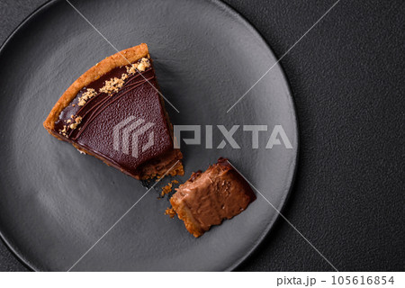 Delicious, fresh, sweet chocolate cake with nuts cut into slices 105616854