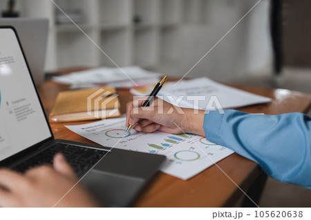 Young business woman looking at computer monitor, analyzing project statistics, marketing research results or statistics data, developing marketing strategy, working at office 105620638