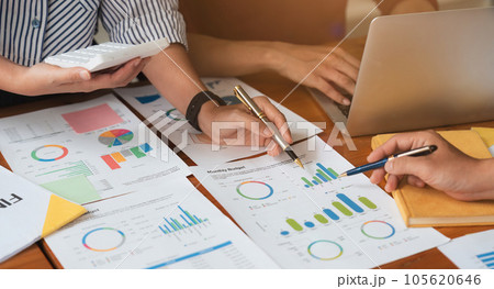 Business team analyzes financial business finance reports on laptop and graph documents during corporate meeting discussions showing successful teamwork, business meeting ideas Business team analyzes financial business finance reports on laptop and graph documents during corporate meeting discussions showing successful teamwork, business meeting ideas 105620646