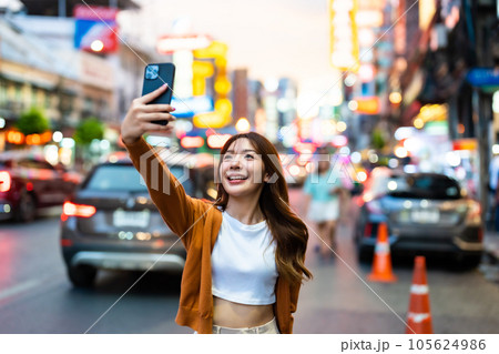 Young Asian tourists standing selfie taking a photo Young Asian tourists standing selfie taking a photo 105624986