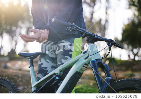 Hand, cycling and outdoor with wrist pain and injury from fitness and mountain bike training. Athlete, muscle strain and sport accident with a person in nature for workout on bicycle with problem Hand, cycling and outdoor with wrist pain and injury from fitness and mountain bike training. Athlete, muscle strain and sport accident with a person in nature for workout on bicycle with problem 105625079