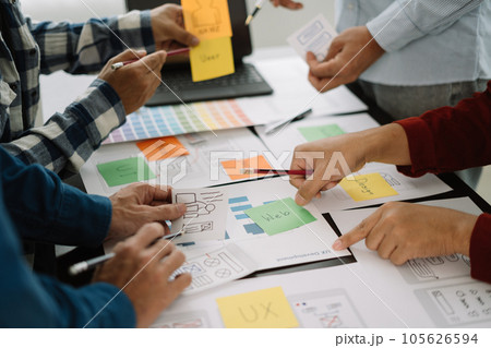 Creative male web designer planning application development for web mobile phone at modern workplace. 105626594