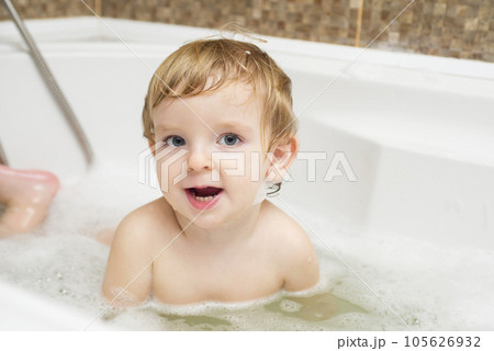 Funny little boy getting a bath in the bathroom. Funny little boy getting a bath in the bathroom. 105626932
