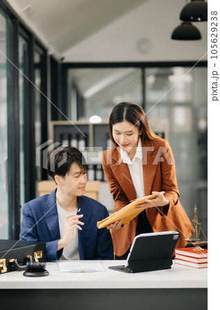 Asian business team and lawyers discussing contract papers sitting at the table. Concepts of law, advice, legal services. at office 105629238