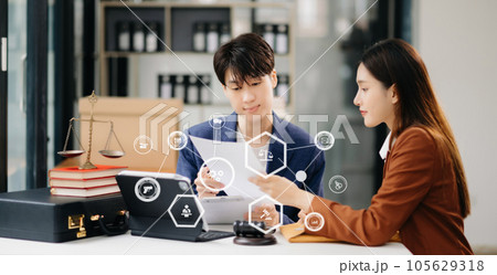 Asian business people and lawyers discussing contract papers sitting at the table. Concepts of law, advice, legal services. with VR icon Asian business people and lawyers discussing contract papers sitting at the table. Concepts of law, advice, legal services. with VR icon 105629318