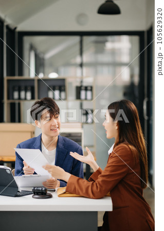 Asian business team and lawyers discussing contract papers sitting at the table. Concepts of law, advice, legal services. at office Asian business team and lawyers discussing contract papers sitting at the table. Concepts of law, advice, legal services. at office 105629320
