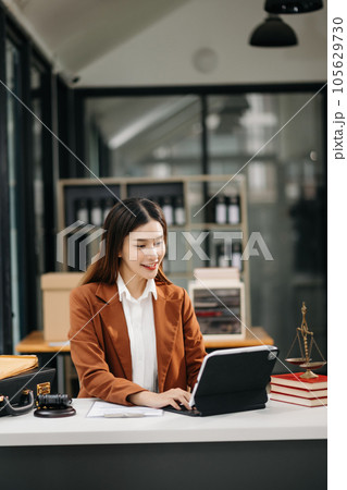 Asian man lawyer working and gavel, tablet, laptop in front, Advice justice and law concept.. 105629730